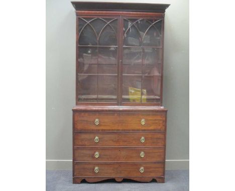 A George III mahogany secretaire bookcase, the upper part enclosed by astragal tracery glazed doors, the base with secretaire