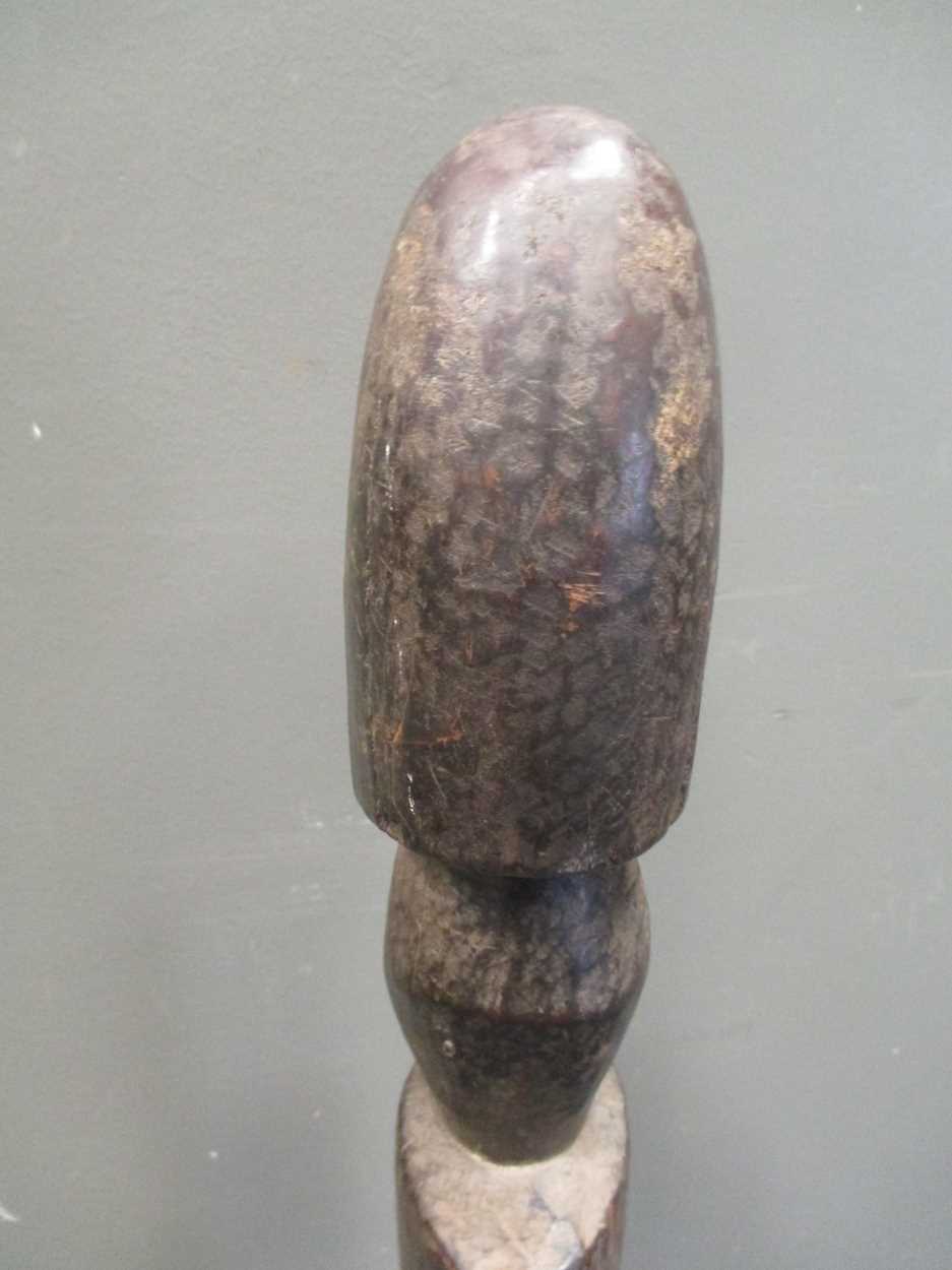 An early 20th century African carved wood fertility statue of phallic