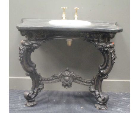 A wash basin set into a serpentine marble surround with metal rococo style stand, 102cm wide