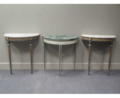 A pair of ebonised and gilt console tables on fluted tapering legs 73cm wide and a green and white painted console table 78cm