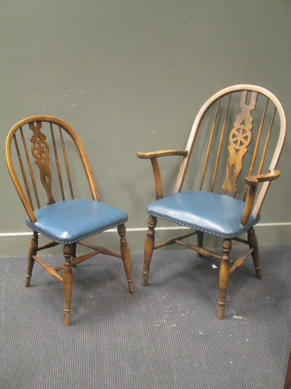 A set of six 20th century wheel back dining chairs to include two