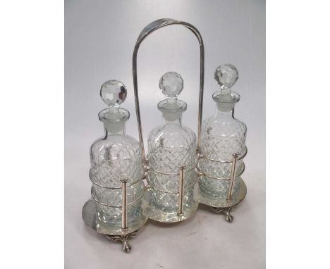 A silver plated three bottle decanter stand, with bottles
