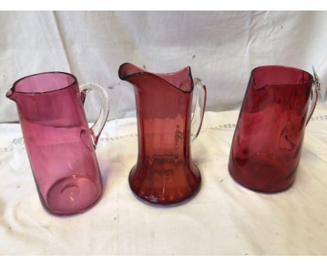  Sale Item:    3 CRANBERRY JUGS   Vat Status:   No Vat   Buyers Premium:  This lot is subject to a Buyers Premium of 15% + Va