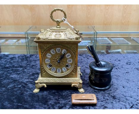 Brass Chiming Mantle Clock, embossed pattern, fist holding handle, Roman numerals.  Together with a pen holder and two founta