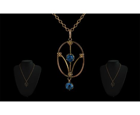 9ct Gold Edwardian Pendant, set with blue stones, suspended on a link chain.