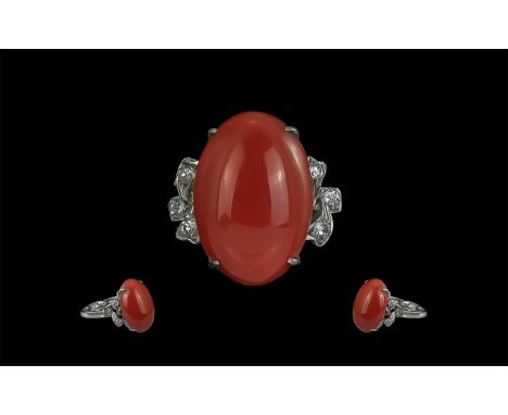 18ct White Gold Jade &amp; Diamond Dress Ring.  Set with a salmon coloured central jade between six round brilliant cut diamo