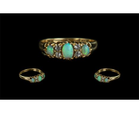 18ct Gold Antique Opal &amp; Diamond Ring, three oval Opals with four round cut diamond spacers, hallmark rubbed tests 18ct. 