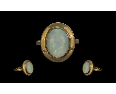 9ct Gold Attractive Single Stone Opal Set Ring. Marked 9ct to Shank. The Oval Shaped Opal of Multi Colours. Ring Size L. Weig