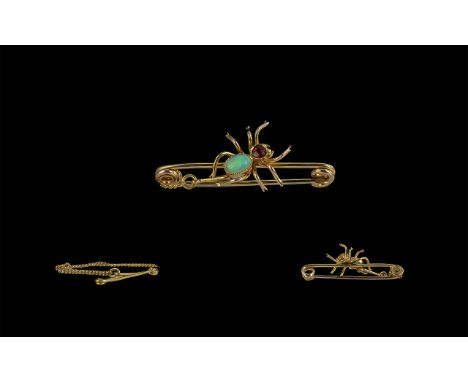 Victorian Period 9ct Gold Figural Spider Brooch. The Spider Set Opal Back and Ruby Head. Marked 9ct with Safety Chain. Weight