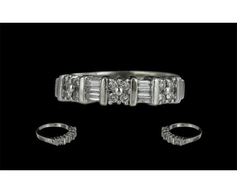 14ct White Gold Pleasing Quality Baguette and Brilliant Cut Diamonds Channel Set Ring. Marked 14ct to Interior of Shank. The 