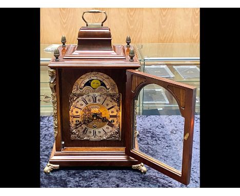 A Modern Reproduction Bracket Mantle Clock with Ormolu decoration, silvered dial, Moon face and Westminster Chime. Housed in 