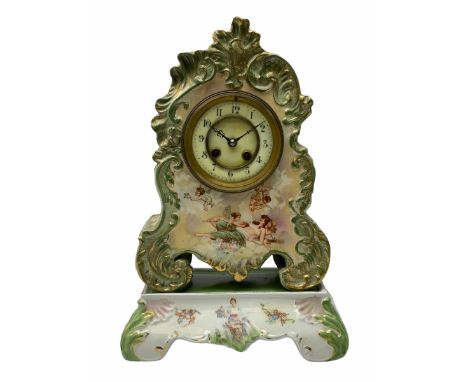 An early 20th century French porcelain clock with rococo scrolling in a cartouche form with gilt highlights, adorned with app