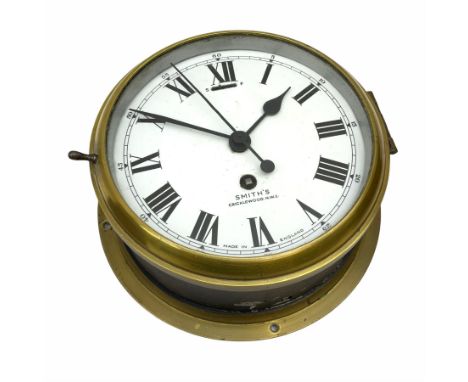 A 20th century Smiths brass cased bulkhead clock with a single train eight-day going barrel movement and balance escapement, 