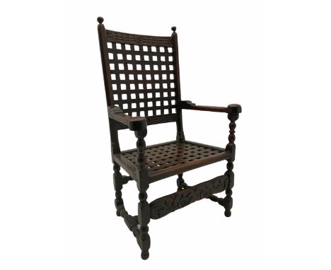 18th century joined oak carver armchair, the cresting rail carved with flower heads over lattice work back and seat, bobbin t