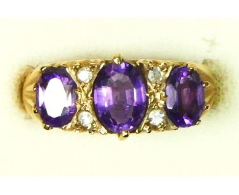 A 9ct gold Victorian style amethyst three stone ring, diamond points between, N, 3gm 