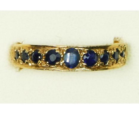 A 9ct and nine stone sapphire set ring, M, 2.7gm 