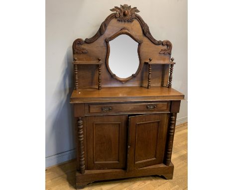 A Edwardian mahogany mirrored back chiffonier, single drawer over hinged doors, open to reveal a shelved interior, turned woo