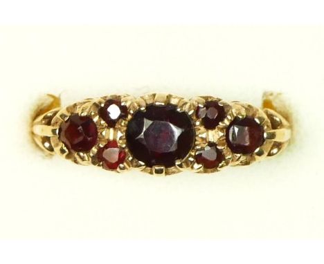 A 9ct gold and garnet set dress ring, N, 3.7gm 