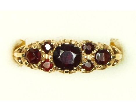 A 9ct gold and garnet set dress ring, N, 3.7gm 