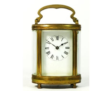 A French brass carriage clock, in oval form with enamelled dial and roman numerals, 8 day cylinder platform movement, raised 