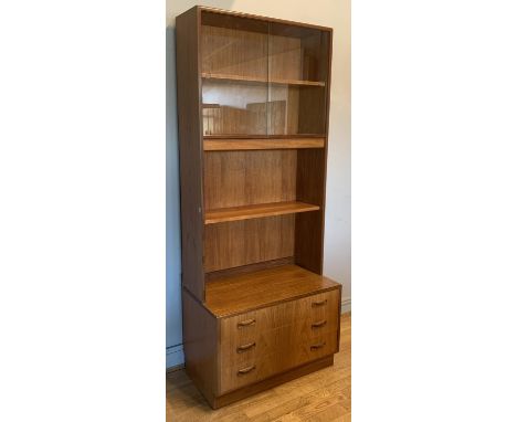 A G Plan bookcase, with glazed sliding doors revealing a single shelf above a illuminated shelf, over three graduated drawers