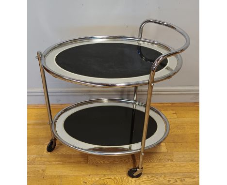 A 1930s Art Deco Savoy cocktail trolley, two tier of oval form, chrome tubular construction houses black mirrored edge plates