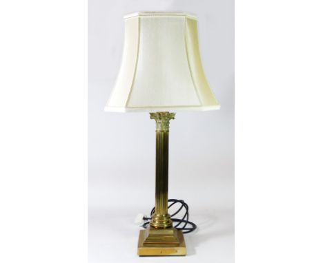 A solid brass table lamp, reeded column on a stepped base with a cream fabric shade.Overall height 76cm. 