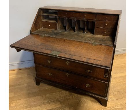 A Georgian mahogany bureau, opens to reveal a fitted interior, over four graduated drawers, brass fittings, on bracket feet, 