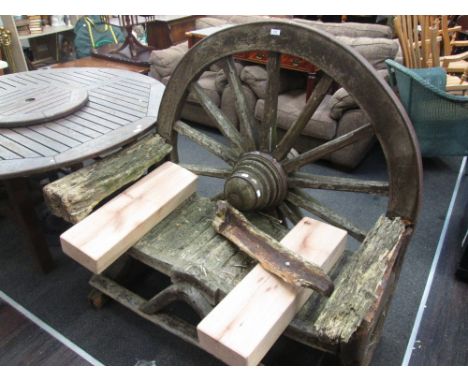A rustic cartwheel garden bench (includes new oak arms)