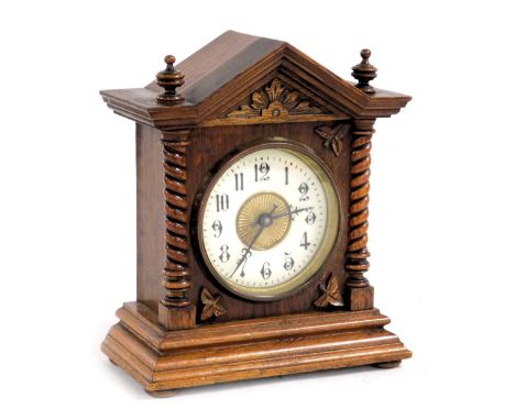 A late 19thC Continental oak cased mantel clock, circular brass dial with enamel chapter ring bearing Arabic numerals, clockw
