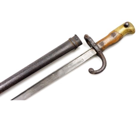 A French St Etienne bayonet, model 1874, engraved to blade Mre d'Armes de S Etienne 1879, in a metal scabbard, 64.5cm wide. 