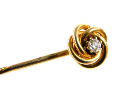 A Victorian diamond set stick pin, in a scrolling mount, yellow metal, approximately 1/16ct, boxed, 1.9g all in.