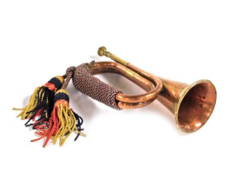 A copper and brass military bugle, with a King's Own Scottish Borders Regiment badged top, stamped KOSB.