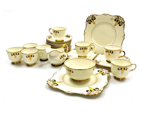 An early 20thC Tuscan plant porcelain tea service, comprising pair of bread plates, cream jug, sugar bowl, eight teacups, twe