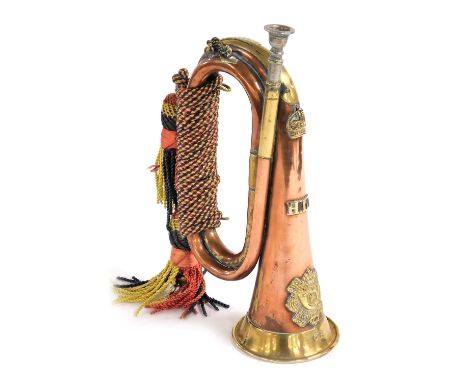A copper and brass military bugle, belonging to the Highland Light Infantry with cipher to front, stamped to side 1917, with 