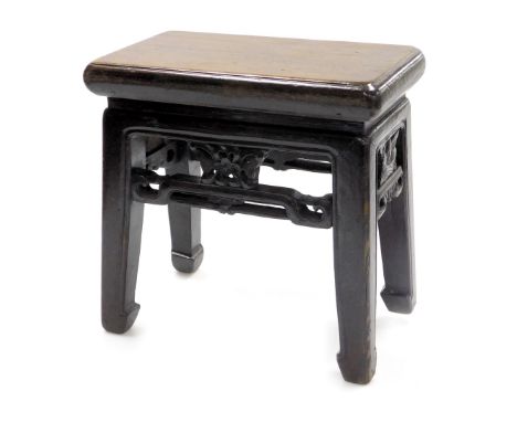 A Chinese hardwood stool, with pierced foliate and scroll stretchers, raised on square legs, 35cm wide. 