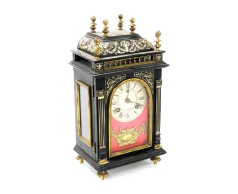 A late 19thC French ebonised and ivory inlaid mantel clock, by A G Mougin, Paris, the silvered chapter ring bearing Roman num