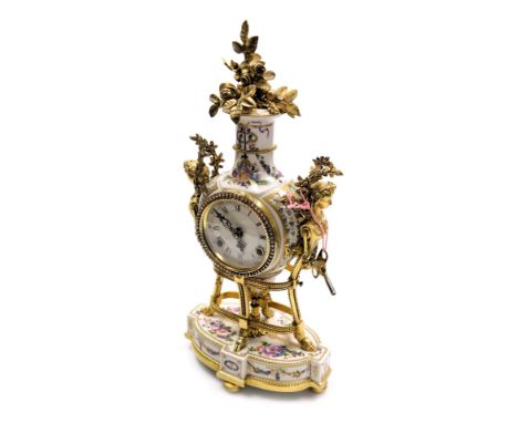 A Louis XIV style porcelain mantel clock, circular enamel dial bearing Roman and Arabic numerals, eight day movement with bel