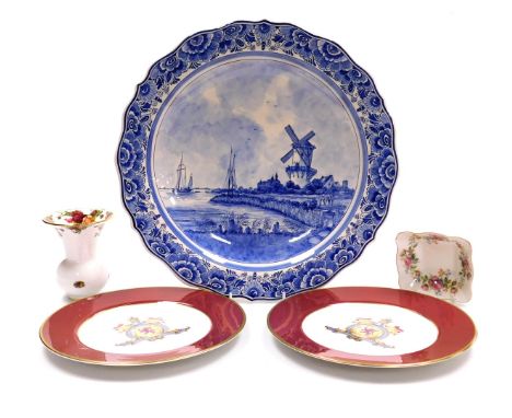 A Delftware blue and white charger, decorated with a canal scene with windmill and figures, within a floral border, 42.5cm wi