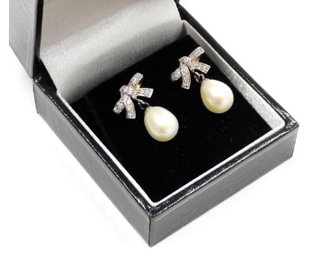 A pair of The Pearl Company cultured baroque pearl earrings, on cz set bow suspensions. 