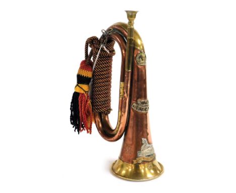 A copper and brass military bugle, stamped with the Royal Lincolnshire cipher, to the side is stamped NTB Africa 1943.