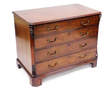 A George III mahogany dressing chest, in the manner of Thomas Chippendale, of four long graduated drawers, the upper drawer o