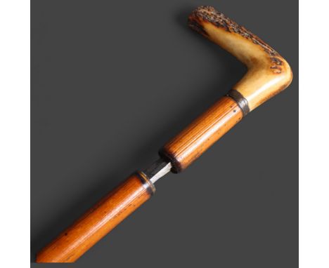 An antique bamboo swordstick, with horn handle, and etched design to the blade, blade length 68.5cm, overall length 90cm.