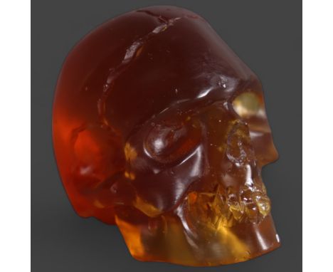 Amber Human Skull. Hand carved and polished from a natural, untreated piece of genuine solid amber. The amber originating fro