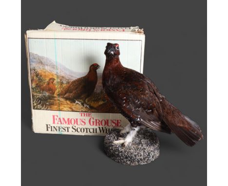 Taxidermy: Red Grouse, with vintage whisky bottles box A full mount adult bird on base. Together with a vintage “The Famous G