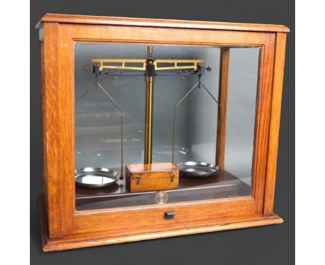 A pair of antique laboratory balance scales, house in an oak glazed cased, scales manufactured by Griffin Tatlock Limited, ca