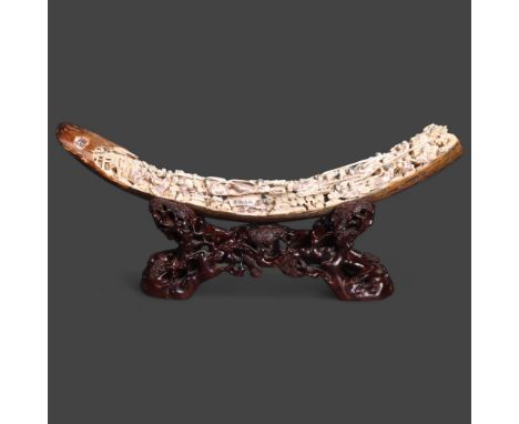 Hand carved Mammoth Tusk on hardwood stand A superb and important piece. The complete ~15,000 year old tusk having been elabo