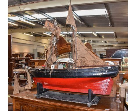 A large painted model of a twin masted fishing trawler on stand, 154cm long, together with a pond yacht hull (2)