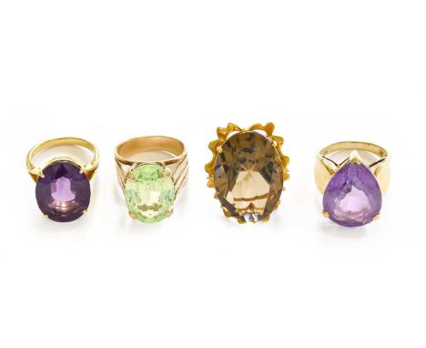 A 9 carat gold smoky quartz ring, finger size J1/2; two amethyst rings, finger sizes M and N; and a green stone ring, stamped