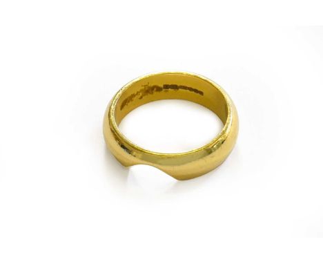 An 18 carat gold band ring, finger size OThe ring is shaped to fit around an engagement ring. Gross weight 8.0 grams.